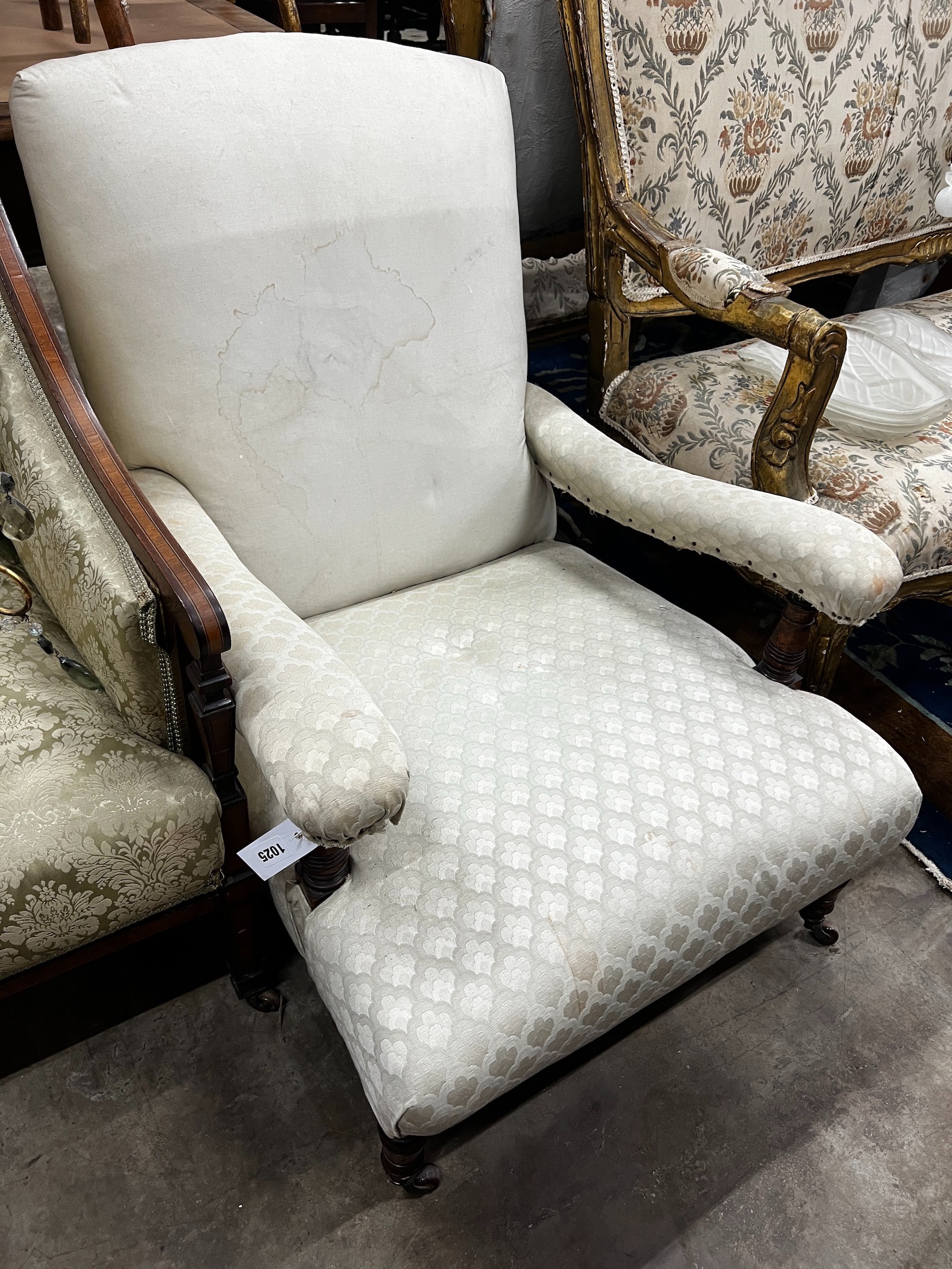 A late Victorian Howard style oak upholstered open armchair, width 69cm depth 90cm height 80cm (back legs cut)